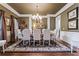 Formal dining room with hardwood floors, elegant chandelier, trim and neutral wall color at 31 Brownson Ct, Acworth, GA 30101