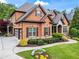 Elegant brick home features a well-manicured lawn, mature landscaping, and a welcoming entrance at 31 Brownson Ct, Acworth, GA 30101