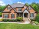 Charming brick home with a well-manicured lawn and covered front porch with stone stairs and landscaping at 31 Brownson Ct, Acworth, GA 30101