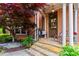 Inviting front porch with stone steps, classic columns, and a charming seating area welcomes you home at 31 Brownson Ct, Acworth, GA 30101