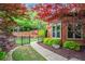 Charming front yard with mature trees, lush landscaping, and a well-maintained lawn leading to the brick home at 31 Brownson Ct, Acworth, GA 30101