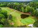 Golf course with lush greenery and a pond, providing a scenic and challenging playing environment at 31 Brownson Ct, Acworth, GA 30101