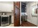 Convenient laundry room with modern washer, dryer, and adjacent cabinet with wine storage at 31 Brownson Ct, Acworth, GA 30101