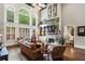 Bright living room features hardwood floors, large windows, and a stone fireplace at 31 Brownson Ct, Acworth, GA 30101