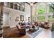 Two-story living room featuring large windows, lots of natural light, and open floor plan with dark wood floors at 31 Brownson Ct, Acworth, GA 30101