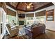 Cozy living room with a stone fireplace, wood beam ceiling, and hardwood floors at 31 Brownson Ct, Acworth, GA 30101