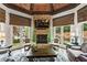Bright, comfortable living room with stone fireplace, wood beam ceiling, and hardwood floors at 31 Brownson Ct, Acworth, GA 30101
