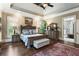 Spacious main bedroom featuring hardwood floors, tray ceiling, and decorative rug at 31 Brownson Ct, Acworth, GA 30101