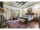 Spacious main bedroom with a stone fireplace, hardwood floors, and bay windows at 31 Brownson Ct, Acworth, GA 30101