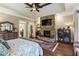 Spacious main bedroom with a stone fireplace, hardwood floors, and tray ceiling at 31 Brownson Ct, Acworth, GA 30101