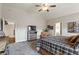 Bright main bedroom featuring a ceiling fan, carpet, and sitting area with lots of natural light at 31 Brownson Ct, Acworth, GA 30101