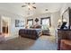Spacious main bedroom with tray ceiling, ceiling fan, carpet and a wrought iron queen bed at 31 Brownson Ct, Acworth, GA 30101