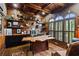 Executive office with wood paneled walls and shelving, custom desk and ceiling with a tin panel design at 31 Brownson Ct, Acworth, GA 30101