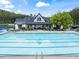 Community pool with a clubhouse, lounge chairs, and well-maintained surrounding area at 31 Brownson Ct, Acworth, GA 30101