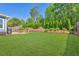 Backyard with green lawn, patio with grill, and outdoor seating at 3909 Obryant Se Cir, Smyrna, GA 30082