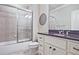 Bathroom featuring a granite countertop vanity, undermount sink, and a shower behind a glass door at 5118 Greythorne Ln, Marietta, GA 30068