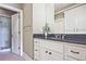 Bathroom featuring a granite countertop vanity, undermount sink, and an open door to the tile shower at 5118 Greythorne Ln, Marietta, GA 30068