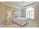 Serene bedroom with tray ceiling, neutral color scheme, large arched window, and stylish furnishings at 5118 Greythorne Ln, Marietta, GA 30068