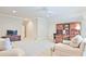 Large bonus room area with a built in desk and cabinets, couch, and television on console table at 5118 Greythorne Ln, Marietta, GA 30068