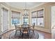 Bright breakfast nook with a round wood table, decorative chandelier, and many windows allowing ample natural light at 5118 Greythorne Ln, Marietta, GA 30068