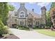 Stunning two-story home with stone accents, lush landscaping, and a circular driveway at 5118 Greythorne Ln, Marietta, GA 30068