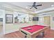 Finished basement area with a pool table and a large pass-through to the bar at 5118 Greythorne Ln, Marietta, GA 30068