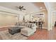Living room with a large seating area, ceiling fan, hardwood floors, and a wet bar area at 5118 Greythorne Ln, Marietta, GA 30068