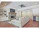 Cozy living room features a stone fireplace, ceiling fan, wood floors, and built-in shelving at 5118 Greythorne Ln, Marietta, GA 30068