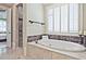 Luxurious main bathroom with a stand alone tub, walk-in shower, and bright windows at 5118 Greythorne Ln, Marietta, GA 30068