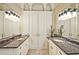 Main bathroom with marble countertops, double sinks, custom cabinets, and decorative light fixtures at 5118 Greythorne Ln, Marietta, GA 30068