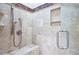 Walk-in shower with built-in seating and shelving with glass shower doors at 5118 Greythorne Ln, Marietta, GA 30068