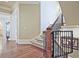 Elegant staircase with hardwood floors, carpeted stairs, and a wrought iron railing at 5118 Greythorne Ln, Marietta, GA 30068