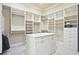 Large walk-in closet with custom shelving, center island, and plenty of space for storage at 5118 Greythorne Ln, Marietta, GA 30068