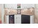 Home wet bar area with granite counters, tile backsplash, a sink, white cabinets, and a wine cooler at 5118 Greythorne Ln, Marietta, GA 30068