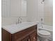 Bathroom with a tiled shower/tub combo, dark wood vanity, and white countertop at 6093 Camden Forrest Ct, Riverdale, GA 30296