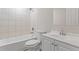 Clean bathroom with tiled shower and tub, white vanity with sink and hardware at 6093 Camden Forrest Ct, Riverdale, GA 30296