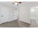 Bedroom showing wood-look flooring, neutral walls, closet, and open door to the bathroom at 6093 Camden Forrest Ct, Riverdale, GA 30296