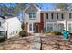 Two story townhouse with red brick, grey stucco, a walkway, and trees in the background at 6093 Camden Forrest Ct, Riverdale, GA 30296