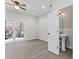 A main bedroom with new flooring, a ceiling fan, recessed lighting, a door to a bathroom, and sliding glass doors at 6093 Camden Forrest Ct, Riverdale, GA 30296