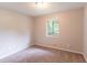 Spacious bedroom with neutral carpet and paint, featuring an abundance of natural light at 6255 Saddlewood Dr, Lithonia, GA 30058