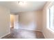 Bright bedroom featuring new gray carpet, neutral paint, and large window at 6255 Saddlewood Dr, Lithonia, GA 30058