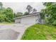 Side view of house featuring two car garage, driveway and greenery at 6255 Saddlewood Dr, Lithonia, GA 30058