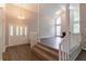Inviting foyer featuring hardwood floors, staircase and vaulted ceilings leading to the living area at 6255 Saddlewood Dr, Lithonia, GA 30058