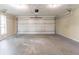 Empty garage with white walls and a large white garage door at 6255 Saddlewood Dr, Lithonia, GA 30058