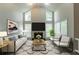 Bright living room with vaulted ceilings, large windows, fireplace, and contemporary furnishings at 6255 Saddlewood Dr, Lithonia, GA 30058