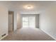 Living room with new carpet and a sliding glass door leading to outdoor space at 6255 Saddlewood Dr, Lithonia, GA 30058