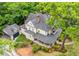 Aerial view showcasing the home's architecture, landscaping, and surroundings with mature trees and a detached garage at 185 Elizabeth St, Atlanta, GA 30307