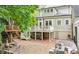 Back exterior of home with large deck, brick patio, and custom-built treehouse at 185 Elizabeth St, Atlanta, GA 30307