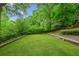 Spacious backyard featuring lush green grass, landscaping, and a fence, perfect for outdoor activities and relaxation at 185 Elizabeth St, Atlanta, GA 30307