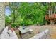 Inviting backyard patio with comfortable seating and a view of the custom treehouse at 185 Elizabeth St, Atlanta, GA 30307